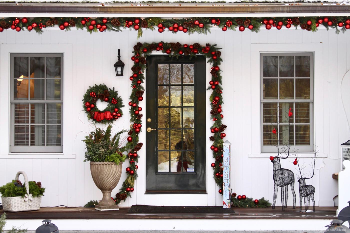 New England home in red holiday decorations by Parterre Garden Services